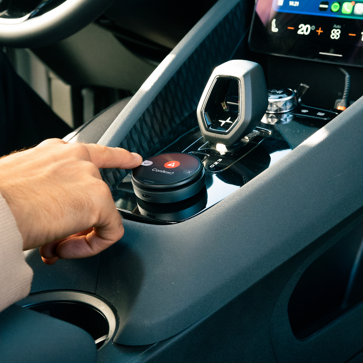 Driver confirming a warning on the device with a thumb